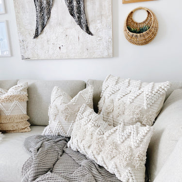 Assorted colorful boho pillows on bed